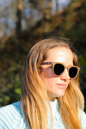 Made with sustainable speckled charcoal wheat straw or coffee residue frame and walnut wood temples, these stylish shades are lightweight, comfortable and eco-friendly with their plastic alternative materials. Fitted with UV400 polarised lenses in a smoke black colour and subtle logo is engraved on the temples. Sunglasses come with a padded pouch and microfibre cleaning cloth.