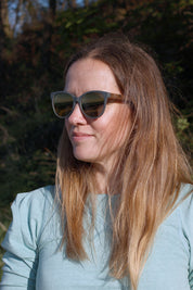 Made with a sustainable speckled wheatstraw or coffee residue frame and walnut wood temples, it's lightweight, comfortable and eco-friendly. Available in charcoal, olive green, coffee and mint frames and fitted with UV400 polarised lenses in smoke, mirrored rose pink and mirrored honey, they are a natural, biodegradable alternative to plastic sunglasses.