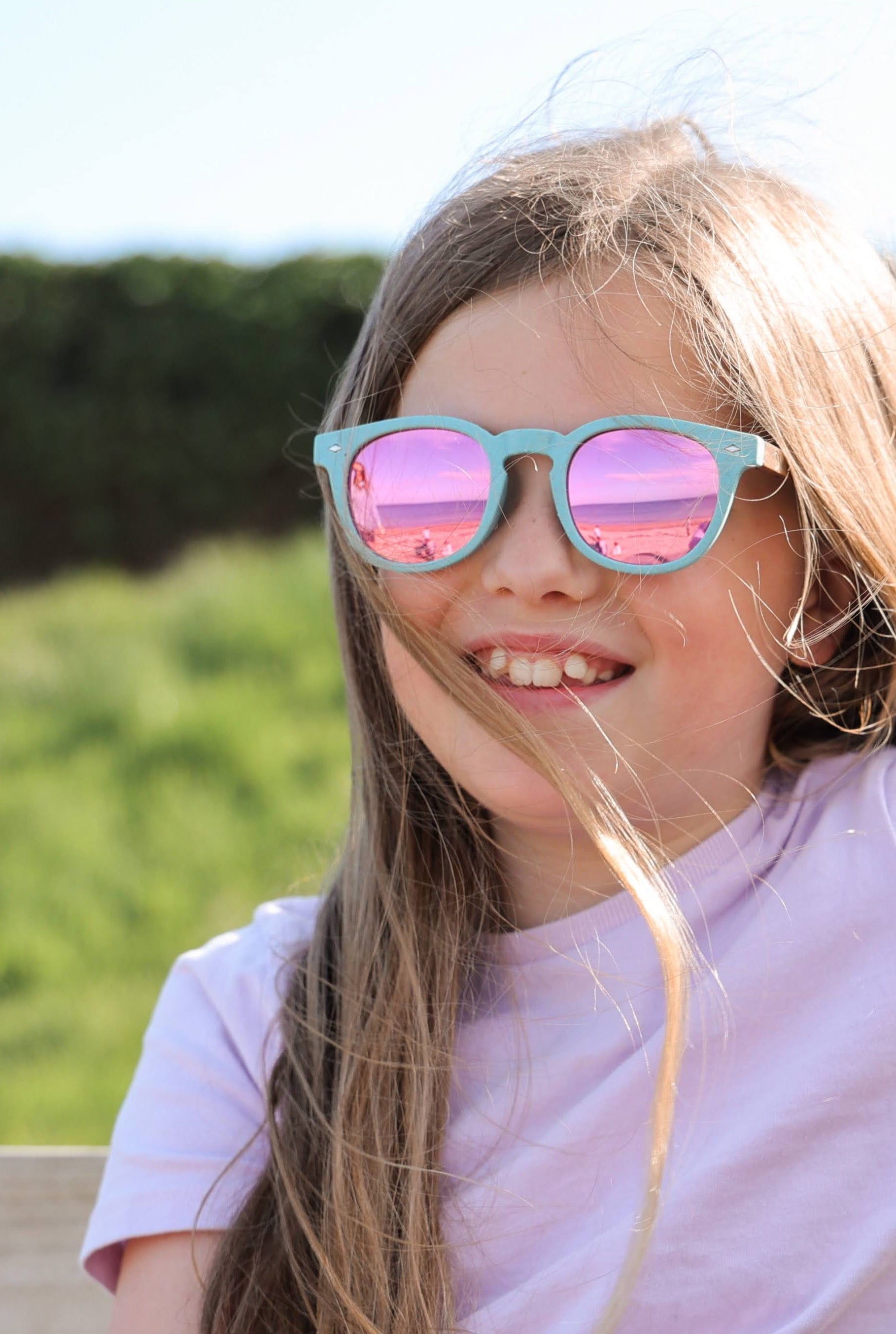 Made with a sustainable speckled wheatstraw frame with walnut wood temples, it's lightweight and comfortable. Fitted with UV400 polarised lenses. Our large child/teen/small adult frame and provides a neater fit without compromising on eye protection.