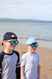 Made with a sustainable speckled wheatstraw frame with walnut wood temples, it's lightweight and comfortable. Fitted with UV400 polarised lenses. Our large child/teen/small adult frame and provides a neater fit without compromising on eye protection.