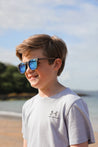 Made with a sustainable speckled wheatstraw frame with walnut wood temples, it's lightweight and comfortable. Fitted with UV400 polarised lenses. Our large child/teen/small adult frame and provides a neater fit without compromising on eye protection.