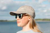 Made with a sustainable speckled wheatstraw frame with walnut wood temples, it's lightweight and comfortable. Fitted with UV400 polarised lenses. Our large child/teen/small adult frame and provides a neater fit without compromising on eye protection.