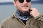 Man wearing black and grey multiway Infinity Band or snood around his neck with design inspired by The Giants Causeway.