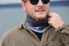 Man wearing black and grey multiway Infinity Band or snood around his neck with design inspired by The Giants Causeway.