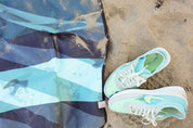 Sustainable waterproof picnic blanket made from recycled polyester, oversized yet packable as it folds flat into a laptop size to slide into a backpack. Zip corner pocket and stake loops and sand pockets to keep it in place. 