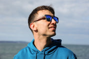 A classic soft rectangular frame. Made with a sustainable speckled charcoal wheatstraw or coffee residue frame and walnut wood temples, it's lightweight and comfortable offering the highest protection with UV400 polarised lenses in a smoke black colour or mirror sky blue. Eco-friendly using plastic alternative frames t…