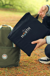 Sustainable waterproof picnic blanket made from recycled polyester, oversized yet packable as it folds flat into a laptop size to slide into a backpack. Zip corner pocket and stake loops and sand pockets to keep it in place. 