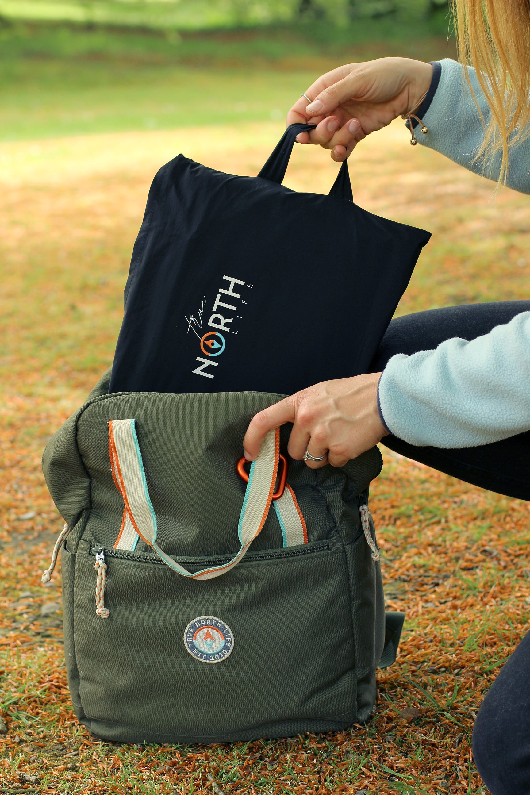 Sustainable waterproof picnic blanket made from recycled polyester, oversized yet packable as it folds flat into a laptop size to slide into a backpack. Zip corner pocket and stake loops and sand pockets to keep it in place. 