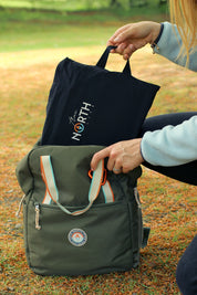 Sustainable waterproof picnic blanket made from recycled polyester, oversized yet packable as it folds flat into a laptop size to slide into a backpack. Zip corner pocket and stake loops and sand pockets to keep it in place. 