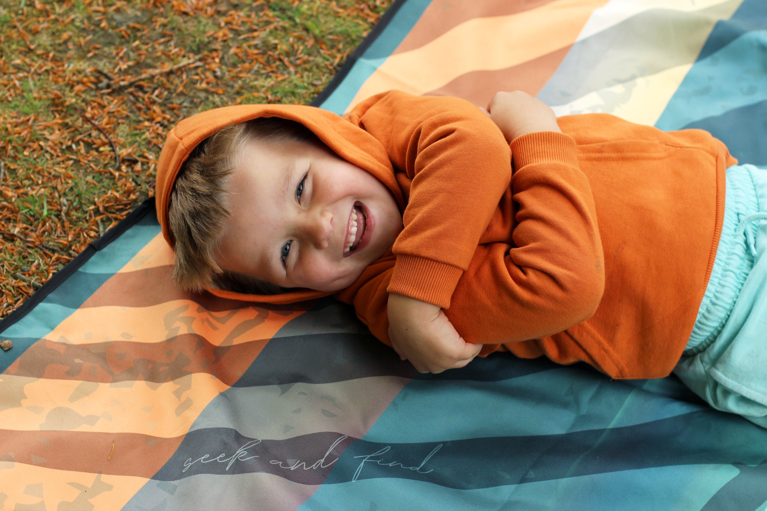 Sustainable waterproof picnic blanket made from recycled polyester, oversized yet packable as it folds flat into a laptop size to slide into a backpack. Zip corner pocket and stake loops and sand pockets to keep it in place. 