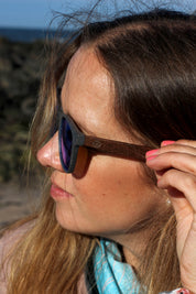 A classic soft rectangular frame. Made with a sustainable speckled charcoal wheatstraw or coffee residue frame and walnut wood temples, it's lightweight and comfortable offering the highest protection with UV400 polarised lenses in a smoke black colour or mirror sky blue. Eco-friendly using plastic alternative frames t…