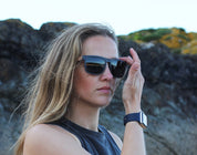 This sustainable rectangular frame is made with a speckled charcoal wheatstraw frame and walnut wood temple and is fitted with UV400 polarised lenses in two colours, smoke and mirrored sky blue. It's lightweight, comfortable and eco-friendly using plastic alternative materials. 