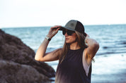 This sustainable rectangular frame is made with a speckled charcoal wheatstraw frame and walnut wood temple and is fitted with UV400 polarised lenses in two colours, smoke and mirrored sky blue. It's lightweight, comfortable and eco-friendly using plastic alternative materials. 